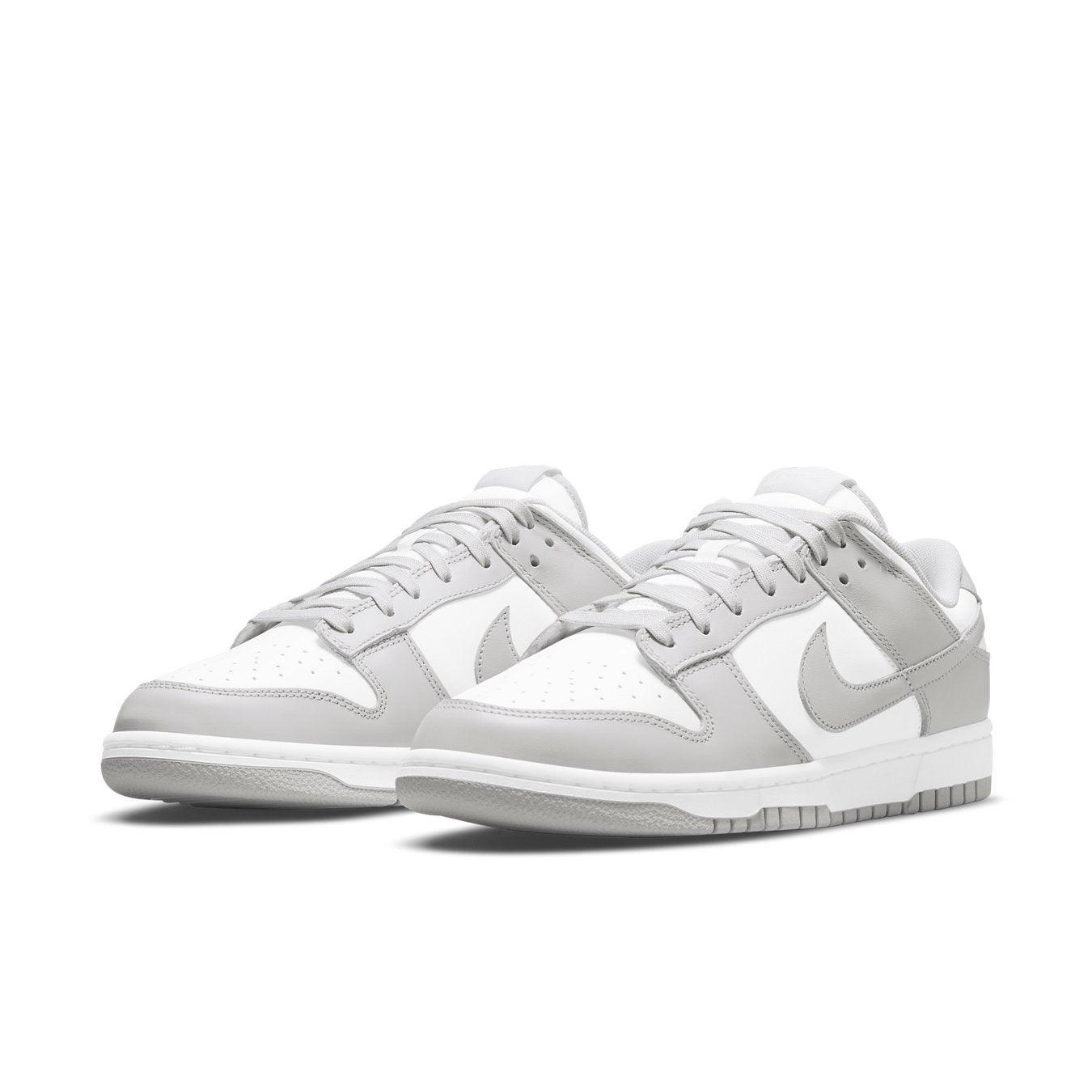 Nike Dunk Low Grey Fog in white and light grey colorway, featuring sleek leather design and classic basketball silhouette.
