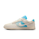 Nike Dunk Low SE LA sneaker in ivory canvas with blue gradient overlays and LA graphic detail.