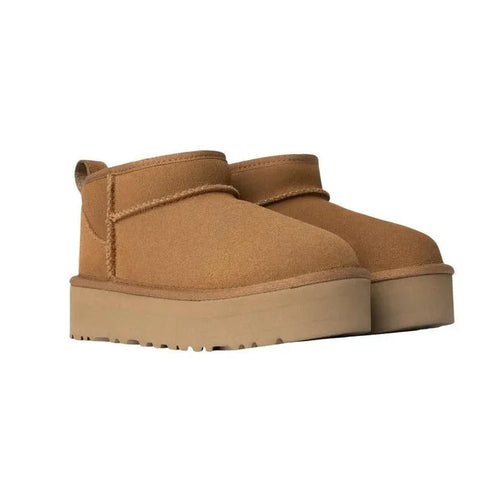 Tan platform boots on a white background