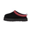 Black slip-on shoe with red and white braided strap on a white background