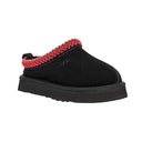 Black slipper with red interior lining on a white background